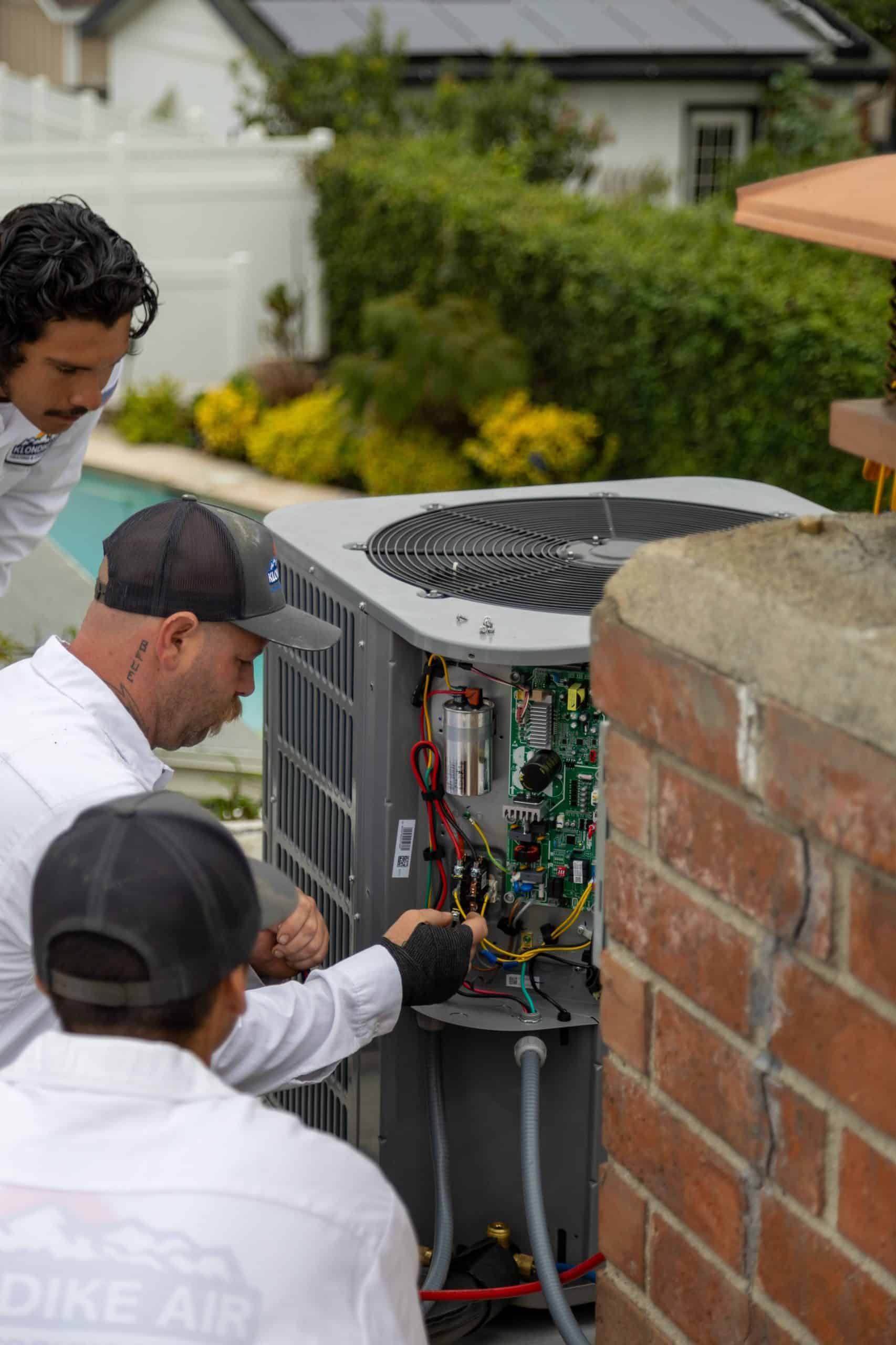 HVAC professional performing maintenance on an air conditioner
