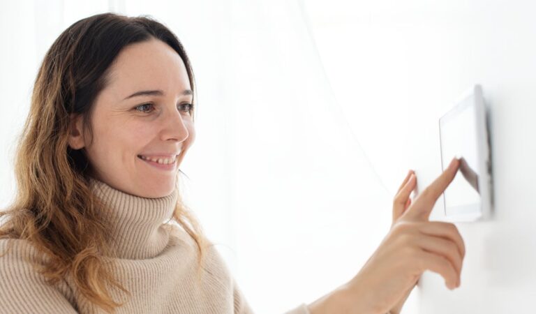 Homeowner Using Modern Thermostat