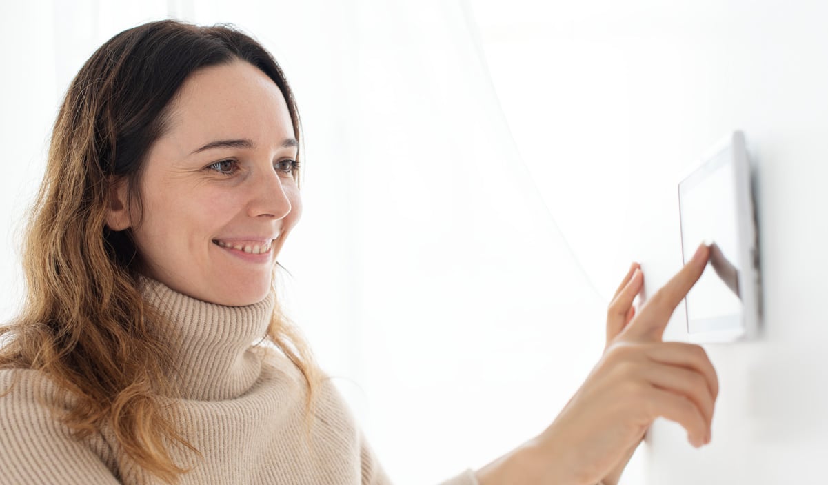 Homeowner Using Modern Thermostat