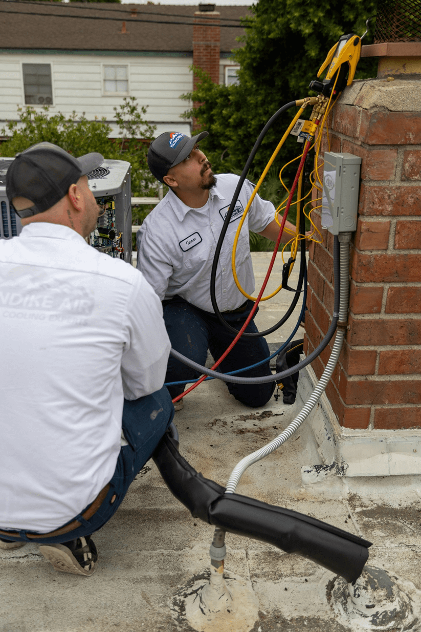 Technician inspecting an AC unit in Orange County