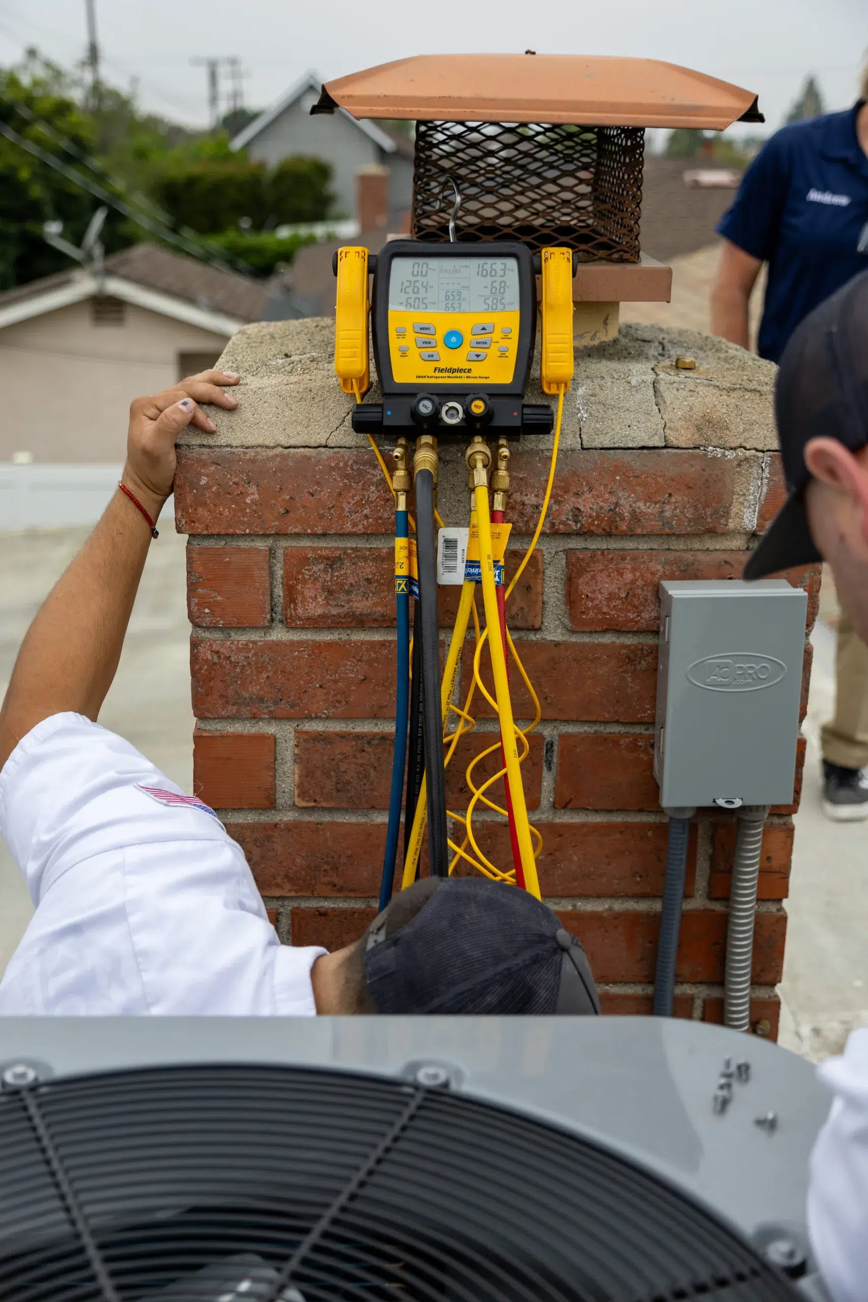 Qualified technicians inspecting HVAC unit