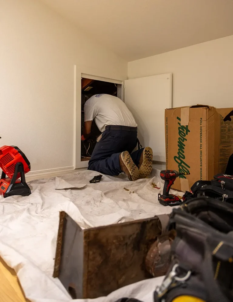 Technician Cleaning an AC Filter
