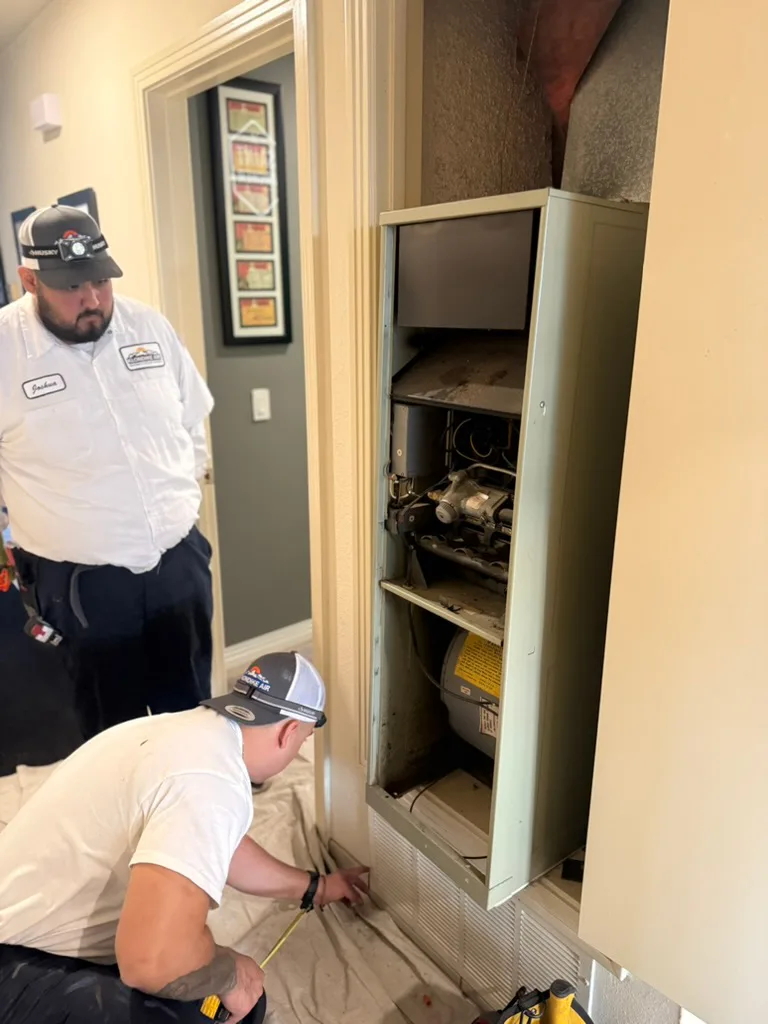 Expert HVAC Technicians Installing Heating System