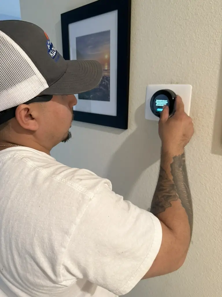 HVAC Technician Checking Smart Thermostat