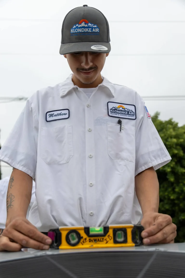 Technician Inspecting an Air Conditioning Unit Outdoors